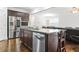 Open kitchen with stainless steel appliances, island with seating, and hardwood flooring at 3219 Colchester St, Douglasville, GA 30135