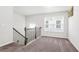 Upstairs landing featuring new carpet, large window and a view to the stairwell at 3219 Colchester St, Douglasville, GA 30135