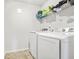 Laundry room featuring new washer and dryer appliances and overhead storage shelf at 3219 Colchester St, Douglasville, GA 30135