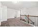 Spacious upstairs landing area with carpet, neutral walls and view to the stairwell at 3219 Colchester St, Douglasville, GA 30135