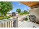 Inviting back porch with brick accents, a view of the meticulously landscaped yard, a boat garage, and beautiful greenery at 3415 Trickum Rd, Woodstock, GA 30188