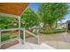 Relaxing back porch with a view of the well-manicured garden, gazebo, and beautiful greenery at 3415 Trickum Rd, Woodstock, GA 30188