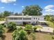Beautiful backyard with a well-manicured lawn, mature trees, covered patios, and a charming white exterior at 3415 Trickum Rd, Woodstock, GA 30188