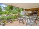Charming backyard patio area with manicured flower beds, a dining set, and a beautifully latticed ceiling at 3415 Trickum Rd, Woodstock, GA 30188