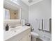 Well-lit bathroom featuring a modern sink, new toilet, and a shower with nice tiling at 3415 Trickum Rd, Woodstock, GA 30188