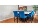 Bright dining area features a large marble table and seating for eight with stylish blue velvet upholstered chairs at 3415 Trickum Rd, Woodstock, GA 30188