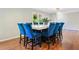 Bright dining area features a large marble table and seating for eight with stylish blue velvet upholstered chairs at 3415 Trickum Rd, Woodstock, GA 30188