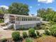 Charming home featuring a sunroom, carport, and meticulously landscaped yard and well-maintained lawn at 3415 Trickum Rd, Woodstock, GA 30188