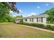 Inviting single-Gathering home with beautiful shrubbery along the walkway and well-maintained lawn at 3415 Trickum Rd, Woodstock, GA 30188