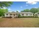 Charming brick ranch featuring manicured landscaping, covered front porch, and a serene neighborhood setting at 3415 Trickum Rd, Woodstock, GA 30188