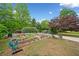Backyard garden area with raised beds provides a serene space for outdoor enjoyment at 3415 Trickum Rd, Woodstock, GA 30188