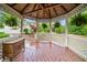 Relax in the gazebo amid beautiful landscaping and mature trees at 3415 Trickum Rd, Woodstock, GA 30188