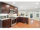 Well-appointed kitchen with stainless appliances, dark wood cabinetry, and modern countertops at 3415 Trickum Rd, Woodstock, GA 30188