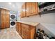 Well-organized laundry room with a washer, dryer, storage cabinets, and granite countertops at 3415 Trickum Rd, Woodstock, GA 30188