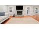 Open living room featuring a fireplace, light-filled windows, hardwood floors and neutral walls at 3415 Trickum Rd, Woodstock, GA 30188