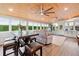 Bright sunroom with wood ceiling, dining table and living space offers natural light and outdoor views at 3415 Trickum Rd, Woodstock, GA 30188