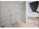A bathroom with a stall shower, toilet, tile floors, and natural light from the window at 6100 Prestige Valley Rd, Morrow, GA 30260