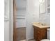 Bathroom features an open door and cabinet with sink at 6100 Prestige Valley Rd, Morrow, GA 30260