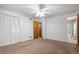 Spacious bedroom featuring a ceiling fan, closet, and adjacent bathroom at 6100 Prestige Valley Rd, Morrow, GA 30260