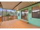 View of the spacious wood deck with metal awning and wooded view at 6100 Prestige Valley Rd, Morrow, GA 30260