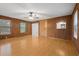 Bright living room with hardwood floors, wood paneling, and a ceiling fan at 6100 Prestige Valley Rd, Morrow, GA 30260