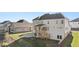 Rear exterior view features a covered porch and wood staircase, ideal for outdoor entertaining at 739 Marlay Sw Ln, Powder Springs, GA 30127