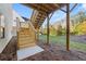 Backyard view of wooden stairs and a new concrete pad, leading to a grassy area at 739 Marlay Sw Ln, Powder Springs, GA 30127