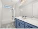 This bathroom features stylish blue cabinets, a large mirror, and a shower at 739 Marlay Sw Ln, Powder Springs, GA 30127