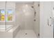 Bright bathroom features a glass enclosed shower with subway tile and brushed metal fixtures at 739 Marlay Sw Ln, Powder Springs, GA 30127