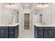 Bathroom featuring double vanities, quartz countertops, and modern gold hardware at 739 Marlay Sw Ln, Powder Springs, GA 30127