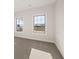 Bright bedroom with plush carpeting and large windows offering serene views of the outdoors at 739 Marlay Sw Ln, Powder Springs, GA 30127