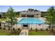 A luxurious community pool featuring ample lounge seating and a modern pool house for residents' enjoyment at 739 Marlay Sw Ln, Powder Springs, GA 30127