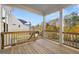 Covered deck with wood railings, columns and view of the backyard and surrounding neighborhood at 739 Marlay Sw Ln, Powder Springs, GA 30127