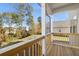 Covered deck with wood railings and view of the backyard and surrounding neighborhood at 739 Marlay Sw Ln, Powder Springs, GA 30127