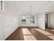 Bright dining room with hardwood floors, wainscoting and modern chandelier at 739 Marlay Sw Ln, Powder Springs, GA 30127