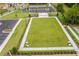 An aerial view of an outdoor green space surrounded by sidewalks, parking lots and lush trees at 739 Marlay Sw Ln, Powder Springs, GA 30127