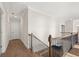 Spacious hallway with hardwood floors and a dark wood and iron railing on the stairway at 739 Marlay Sw Ln, Powder Springs, GA 30127