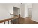 Hallway with hardwood floors, white walls and doors, leading to a bathroom and other rooms at 739 Marlay Sw Ln, Powder Springs, GA 30127