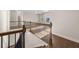 Upstairs hallway features a stained wood and black metal railing, hardwood floors, and natural light at 739 Marlay Sw Ln, Powder Springs, GA 30127