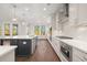 Spacious kitchen with stainless steel appliances, white cabinetry, and a large island with a sink and dishwasher at 739 Marlay Sw Ln, Powder Springs, GA 30127