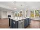 Open concept kitchen with a large island featuring a sink, and views to the living room with a fireplace at 739 Marlay Sw Ln, Powder Springs, GA 30127