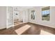 Living room with hardwood floors, bright windows, and glass doors leading to another room at 739 Marlay Sw Ln, Powder Springs, GA 30127