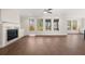Bright living room with hardwood floors, a fireplace, and large windows with beautiful views at 739 Marlay Sw Ln, Powder Springs, GA 30127