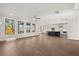 Open-concept living area with hardwood floors, a kitchen island, and large windows at 739 Marlay Sw Ln, Powder Springs, GA 30127