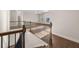 Open loft area with dark wood railing, hardwood floors and natural light at 739 Marlay Sw Ln, Powder Springs, GA 30127