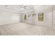 Bright and airy main bedroom featuring large windows, carpeted floors, and a ceiling fan at 739 Marlay Sw Ln, Powder Springs, GA 30127