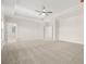 Expansive primary bedroom with tray ceilings, neutral carpet, and abundant natural light from windows at 739 Marlay Sw Ln, Powder Springs, GA 30127