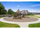 Vibrant playground featuring slides and climbing structures, bordered by walking paths and landscaping at 739 Marlay Sw Ln, Powder Springs, GA 30127