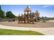 Community playground featuring a wooden playset with slides, climbers, and swings on a mulch-covered ground at 739 Marlay Sw Ln, Powder Springs, GA 30127