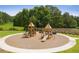 Community playground with climbing structures and slides, surrounded by a cushioned surface and grassy areas at 739 Marlay Sw Ln, Powder Springs, GA 30127